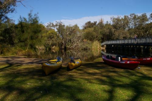 Kayaks on the shore line of the river. 