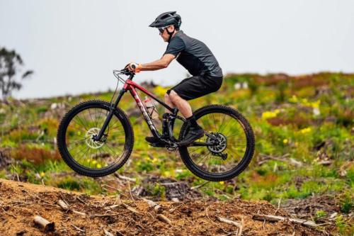 Person riding mountain bike on a trail. 