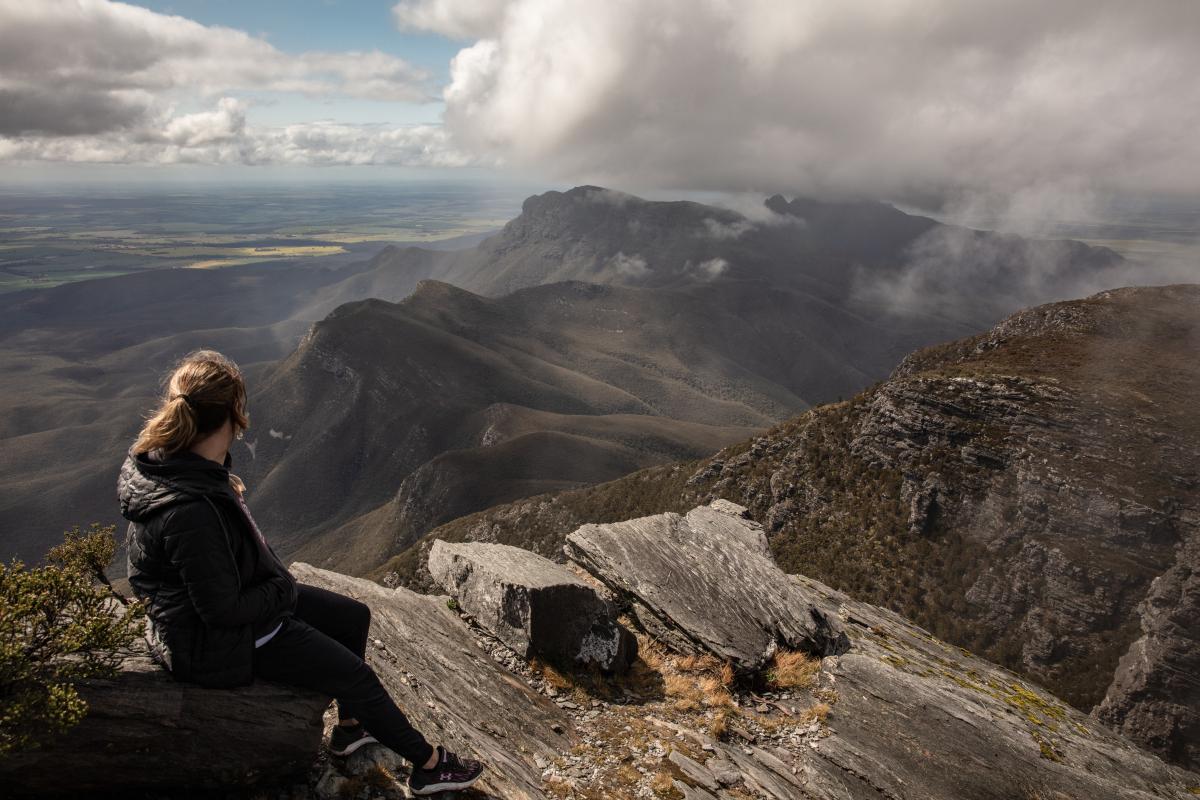 View from Bluff Knoll person sitting on mountain looking at view of peaks